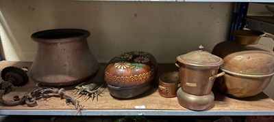 many pots and pans on a shelf in a room