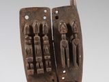 an image of a sculpture of two people on a wooden base