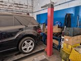 a car that is parked in a garage next to a pile of boxes