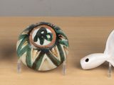 three ceramic objects that are sitting on a table