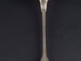 an old silver spoon with a spoon handle on a black background