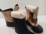 pair of black and tan boots with fur linings on them