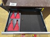 a drawer that has two red bottles in it