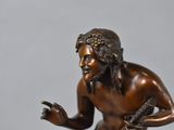 bronze statue of a man holding a fish on a marble base