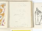 quatre livres ouverts, ornés de dessins, posés sur une surface blanche