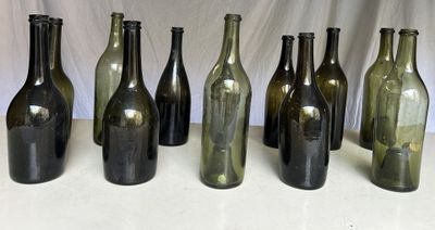 several empty wine bottles are lined up on a table