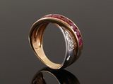 a close up of a gold ring with ruby and diamonds
