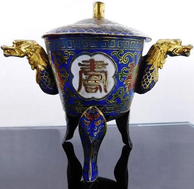 a blue and gold vase with a dragon on it