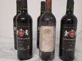three bottles of wine are lined up on a table