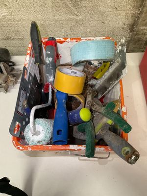 a basket full of assorted tools on a table