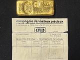 a close up of a piece of paper with a gold bar on it