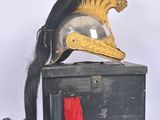 a black box with a gold helmet on top of it