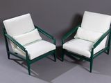 pair of green and white chairs with white cushions on a grey background