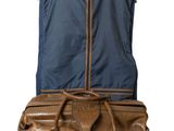 a brown suitcase with a blue cover on top of it