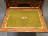 a wooden desk with a green rug on it
