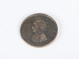 an old coin with a woman ' s face on it on a white surface