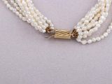 three strand pearl necklace with gold tone clasp