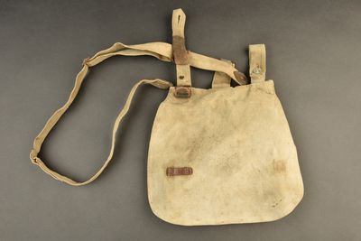 a close up of a bag on a table with a strap
