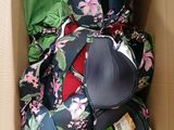 a cardboard box with a bunch of clothing inside of it