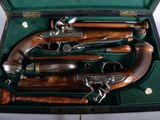 four guns in a case on a table