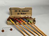 six wooden crochet needles in a box with a penny in the background