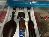 three wooden spoons and two wooden spoons in a display case