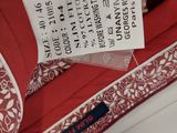 the label on a red dress is attached to a white shirt
