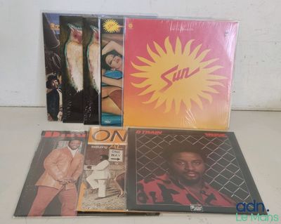 three cds of various albums, including a man in a suit and a woman in a pink shirt