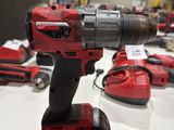 a red drill that is sitting on a table