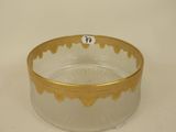 a glass bowl with a gold rim on a white surface