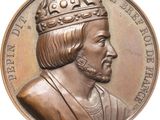 an image of a close up of a bronze medal with a crown on it