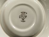 a white plate with a crown on it on a table