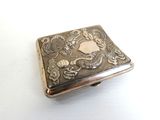 a silver box with a picture on it on a white surface