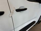 a sticker on the door handle of a white car