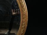 a reflection of a man in a mirror on the wall