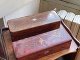 a small wooden table with two boxes on top of it