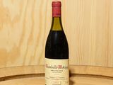 une bouteille de vin posée sur un tonneau