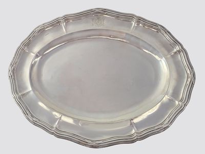 an oval silver plate on a white background with a silver rim