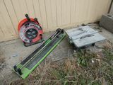 two tools that are laying on the ground next to a building