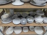 a lot of plates and bowls on a shelf