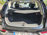 the back of a car with its trunk open and the back seats folded down