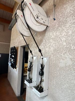a white wall with a bunch of wires attached to it
