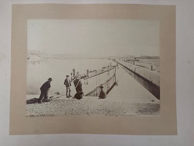 a black and white photo of a group of people on the beach