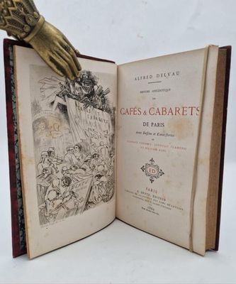 an open book with a gold hand resting on top of it
