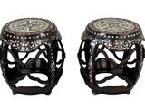 pair of black and white ceramic stools with floral designs