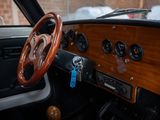 dashboard of a car with a wooden steering wheel and wooden dash board