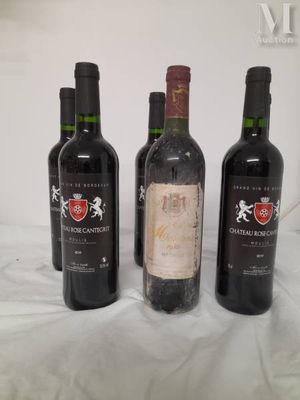 three bottles of wine are lined up on a table