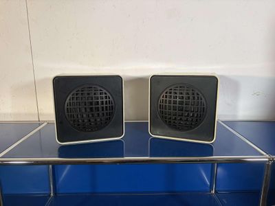 two speakers that are sitting on top of a glass table