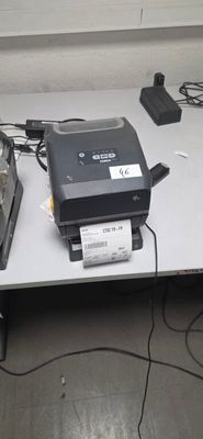 une imprimante posée sur une table à côté d'un ordinateur portable