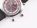 a close up of a watch on a white surface